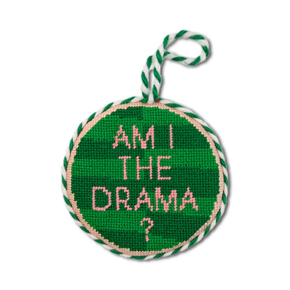 Green round needlepoint ornament with 'Am I the drama?' text on a white background