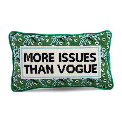 Decorative pillow with text 'More Issues Than Vogue' on a green background