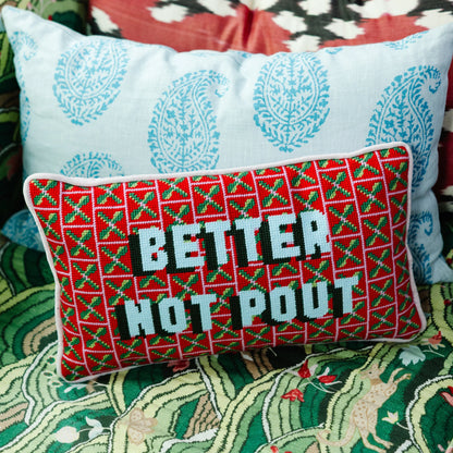 Decorative pillow with 'Better Not Pout' text on a patterned fabric background