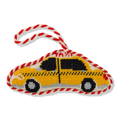 Toy in the shape of a yellow taxi with red and white rope handle on a white background