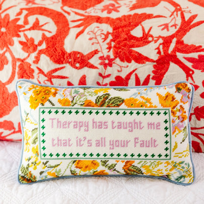 Decorative pillow with floral design and text on a floral background
