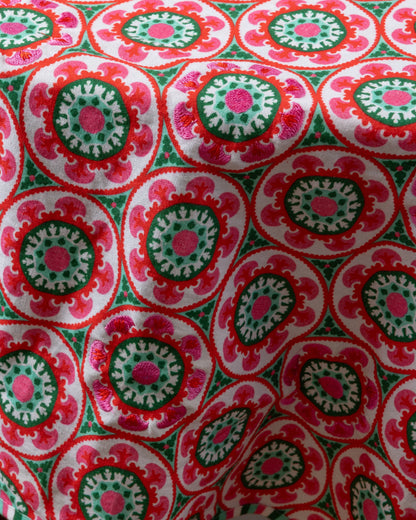 Close-up of fabric with red and green circular pattern