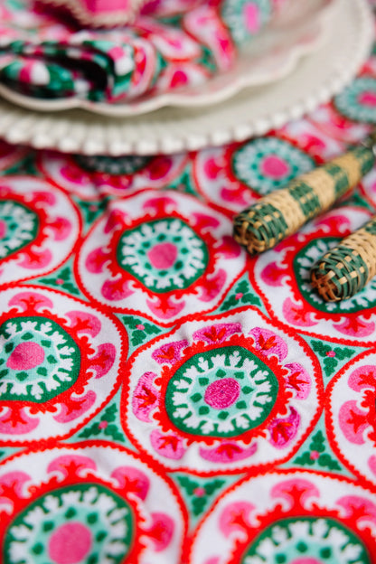 Colorful fabric with circular patterns and a small decorative item on top