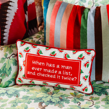 Decorative pillow with a Christmas-themed quote on a colorful background