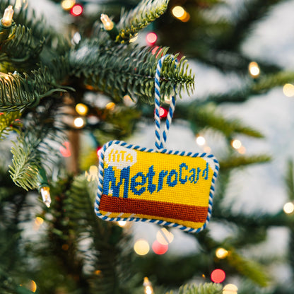 Decorative ornament shaped like a MetroCard hanging on a Christmas tree.