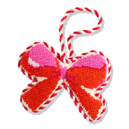Decorative candy cane ornament with red, pink, and white colors on a white background