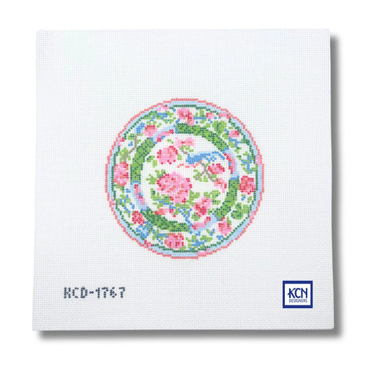 A chinoiserie patterned plate with pink roses and leaves.
