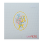 needlepoint design of a floral bouquet with a yellow bow on light blue fabric, featuring the text 'LA FETE'.