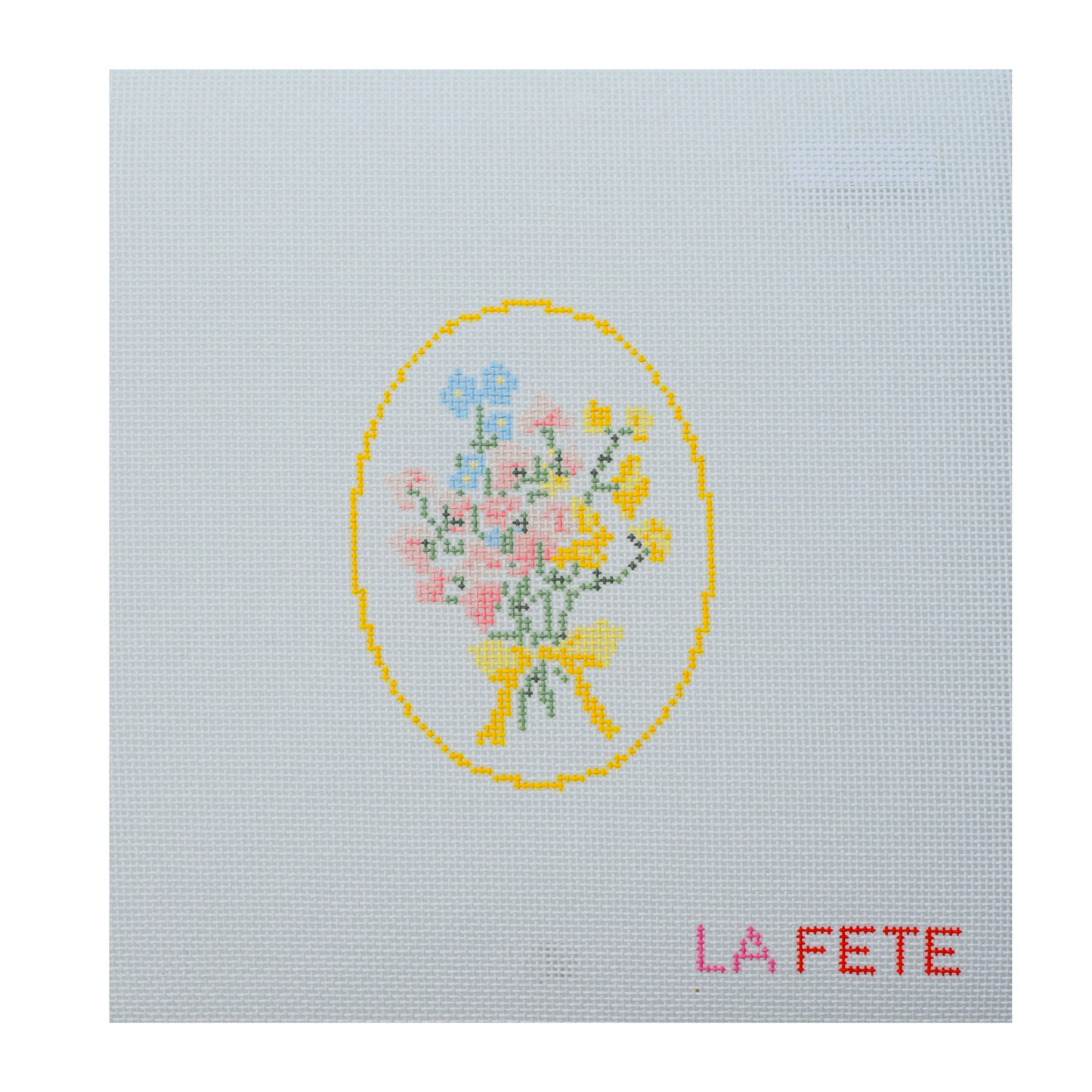 needlepoint design of a floral bouquet with a yellow bow on light blue fabric, featuring the text 'LA FETE'.
