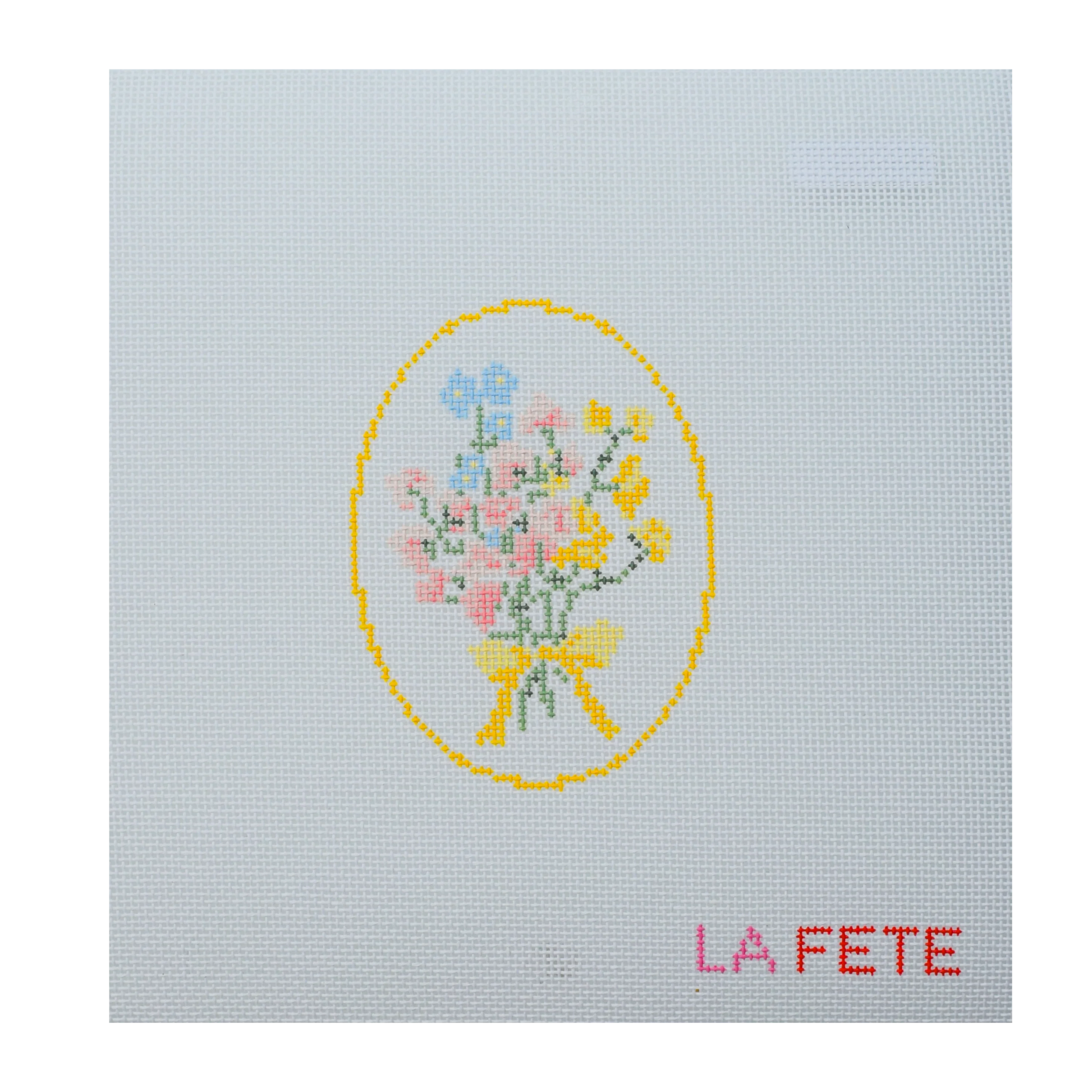 needlepoint design of a floral bouquet with a yellow bow on light blue fabric, featuring the text 'LA FETE'.