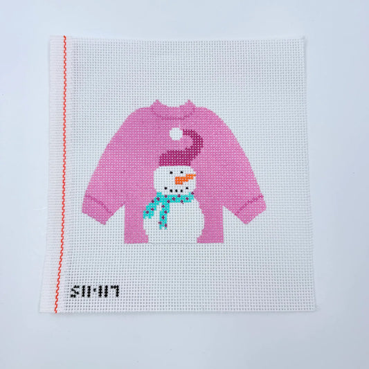 Cross-stitched design of a pink sweater-wearing snowman on fabric with 'simin' branding.