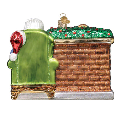 Decorative Christmas ornament shaped like a train car with green exterior and red and gold accents.