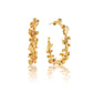 Gold hoop earrings with floral designs on a white background