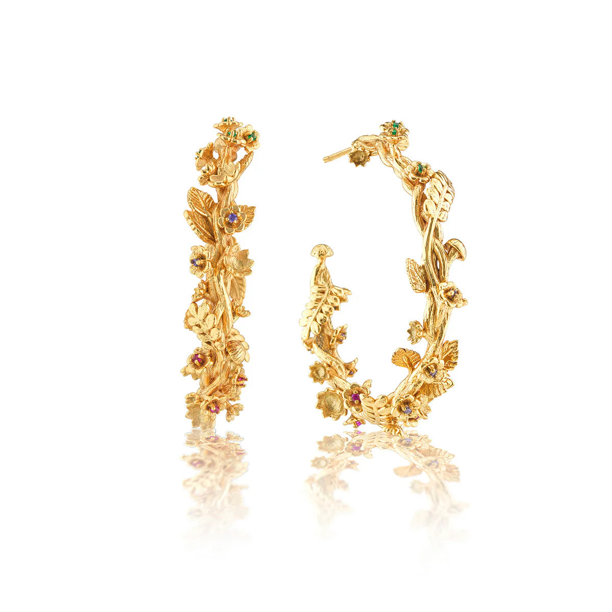 Gold hoop earrings with floral designs on a white background