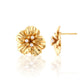 Gold floral earrings with pearl centers on a white background