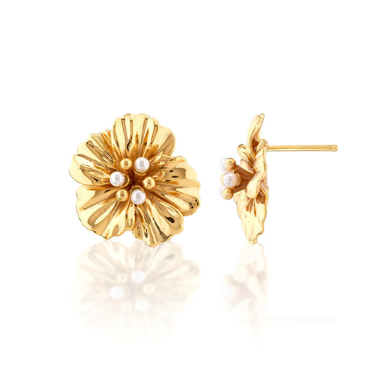 Gold floral earrings with pearl centers on a white background