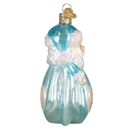 Glass ornament of a Santa Claus figure with blue and white attire on a white background