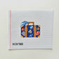 Cross-stitched design of a suitcase with colorful patterns on a white background