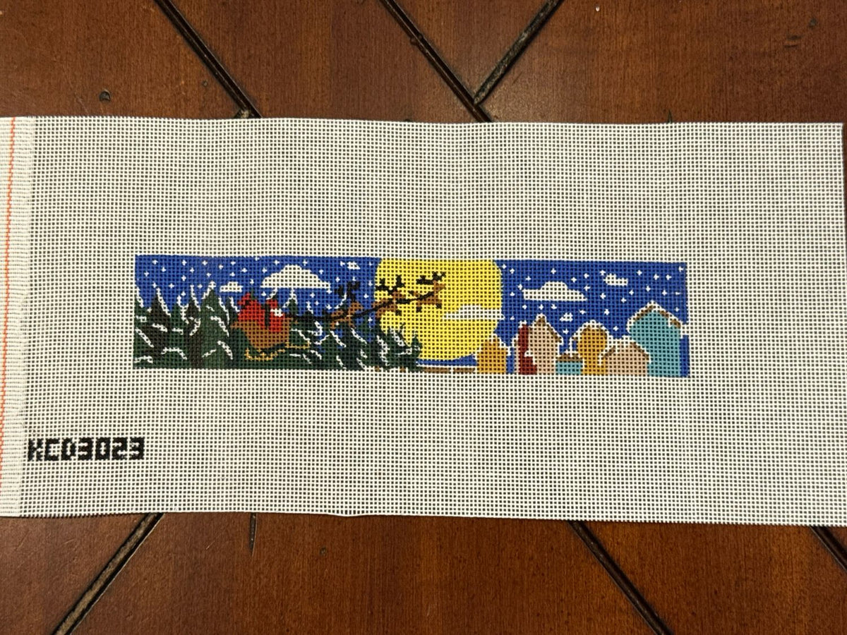 Needlepoint canvas with reindeer pulling sleigh design.