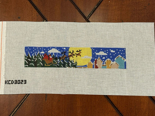 Needlepoint canvas with reindeer pulling sleigh design.