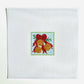 Cross-stitched design of a red bow with gold balls on white fabric