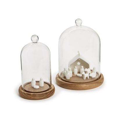 Two glass dome models on wooden bases with white figures inside.