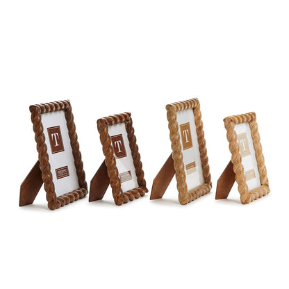 Four small photo frames with brown and beige designs on a white background