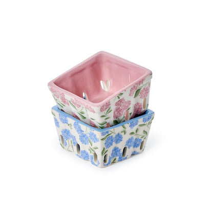 Two square ceramic berry crates with floral patterns, one in blue and one in pink.