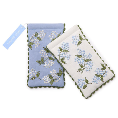 Two embroidered coasters with floral patterns on a white background