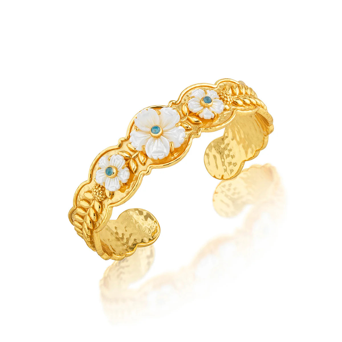 Gold ring with floral designs on a white background