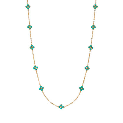 Gold necklace with turquoise flower-shaped beads on a white background