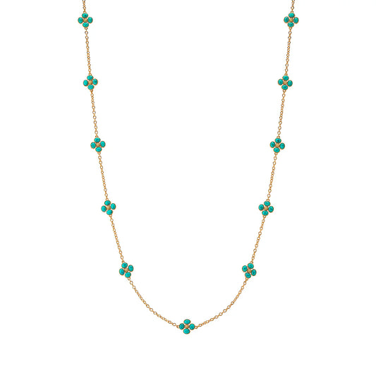 Gold necklace with turquoise flower-shaped beads on a white background