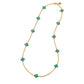 Gold necklace with turquoise flower-shaped stones on a white background