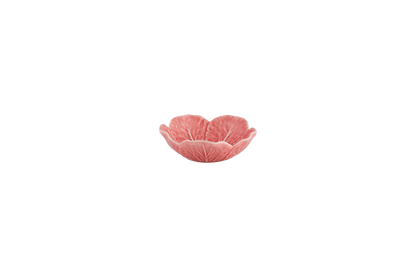 Pink ceramic bowl with leaf design on a white background