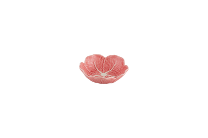 Pink ceramic bowl with a floral design on a white background