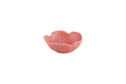 Pink ceramic bowl with leaf pattern on a white background
