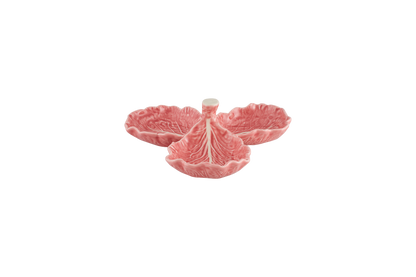 Pink ceramic dish with floral design on a white background