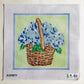 Cross-stitched design of a basket with blue flowers on fabric.