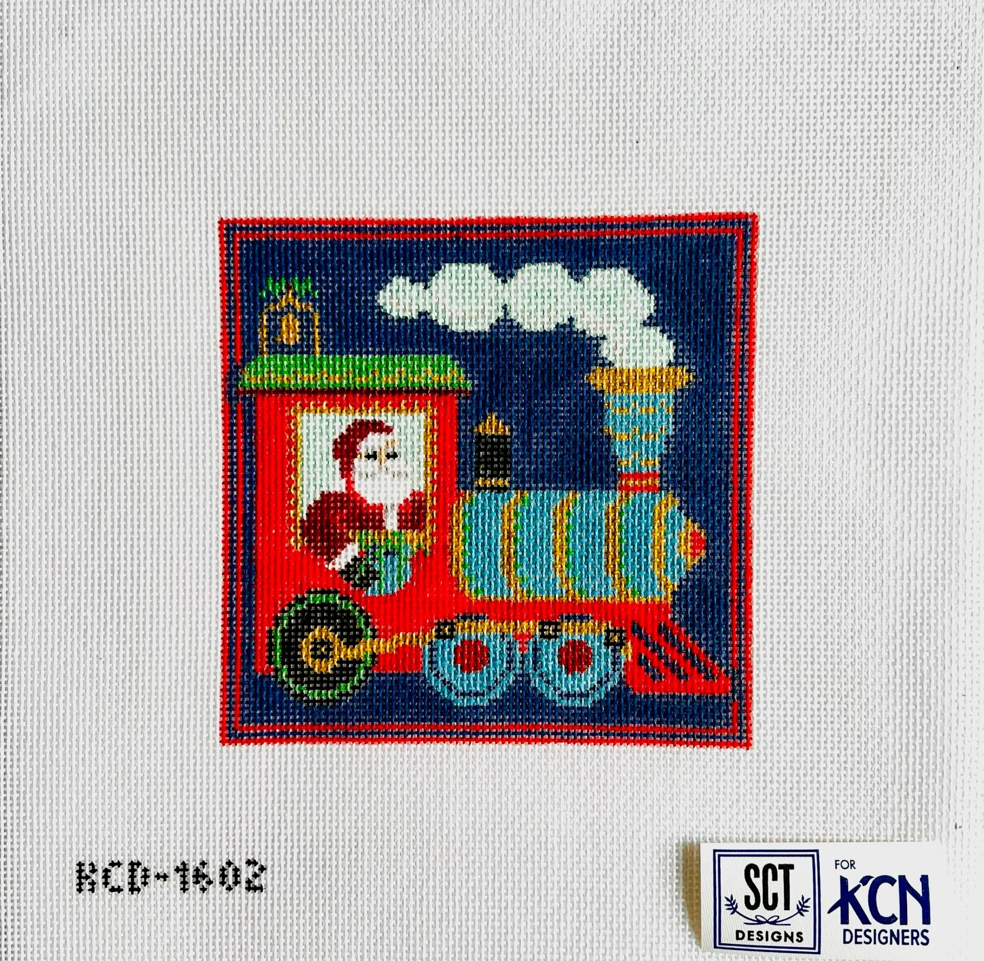 Colorful train design on fabric with SCT Designs and KCN Designs logos.