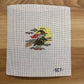 Cross-stitched design of a rooster on a white fabric background