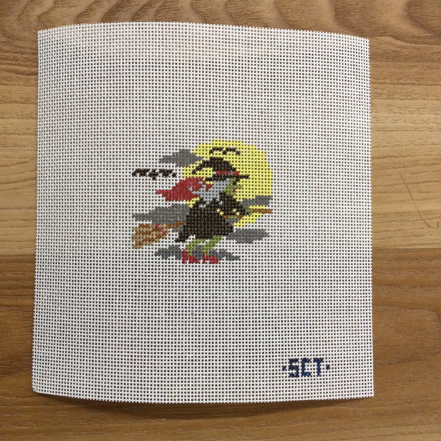 Cross-stitched design of a rooster on a white fabric background