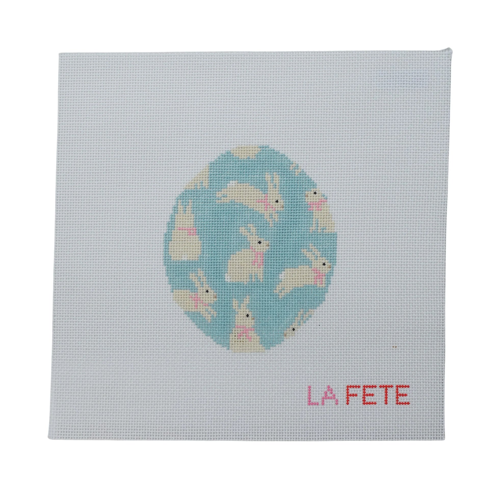 Canvas with a blue Easter egg design featuring bunnies and 'La Fete' branding on a light gray background.
