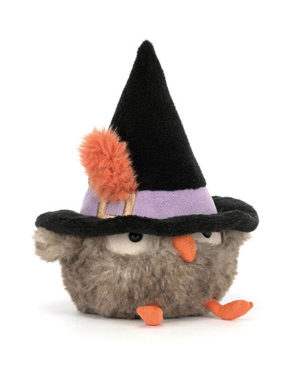 Plush toy owl wearing a witch hat on a white background