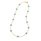 Gold necklace with turquoise flower-shaped beads on a white background