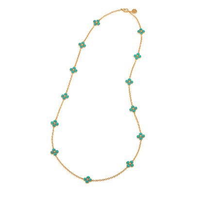Gold necklace with turquoise flower-shaped beads on a white background