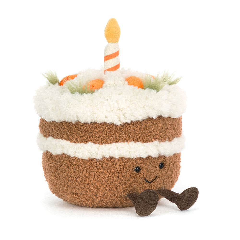 Plush toy cake with candles on a white background