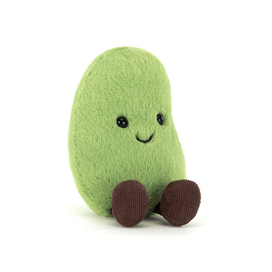 Green plush toy with a smiling face on a white background