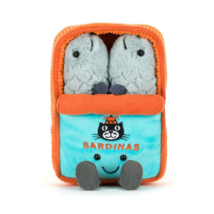 Plush toy with two small gray plush animals inside an orange container labeled 'Sardinas' on a white background.