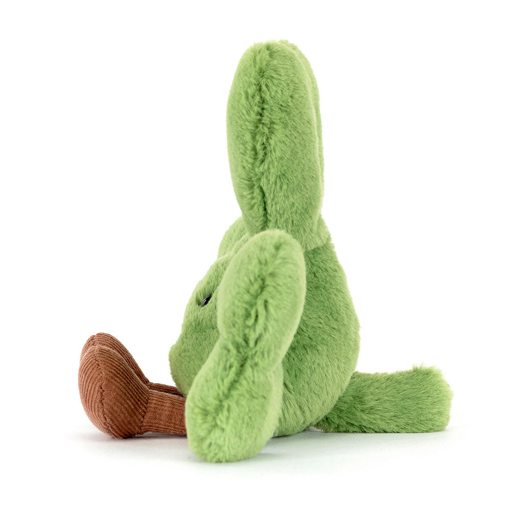 Green plush toy with brown feet on a white background