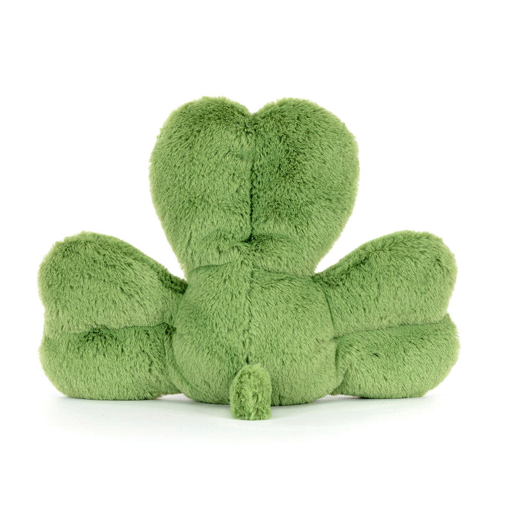Green plush toy shaped like a four-leaf clover on a white background